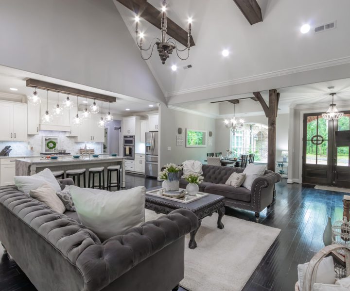 Stylish living room decorated in neutral tones, showcasing a modern fireplace, plush furnishings, and decorative lighting that adds a touch of elegance.